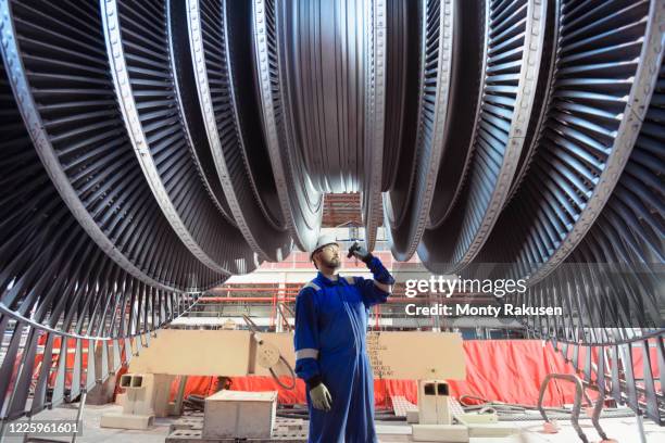 engineer inspecting a turbine in a  nuclear power station. - nuclear power station imagens e fotografias de stock