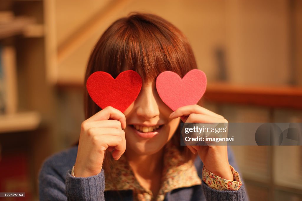 Woman holding heart shapes