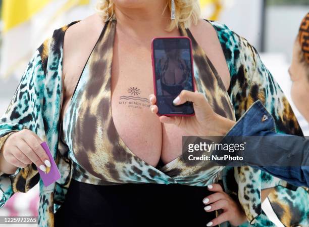 Woman takes photo of Mila Kuznetsova with 13th breast size during the Ukrainian record in a nomination 'The largest female natural breasts' in Kyiv,...