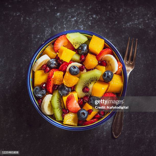 healthy homemade fruit salad bowl shot from above. - fruit salad stock pictures, royalty-free photos & images