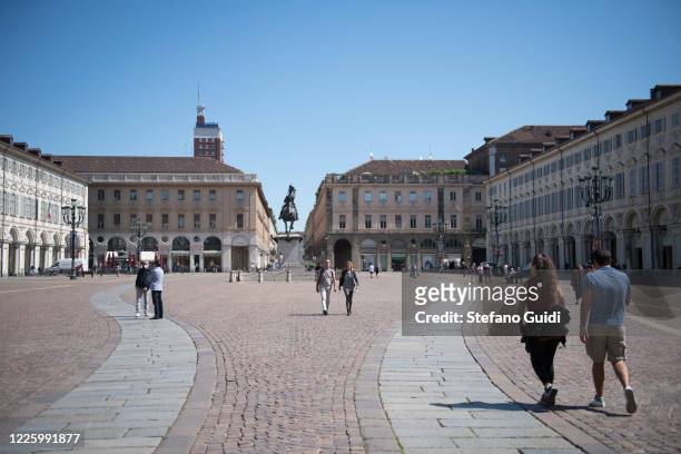General view of people with and without protective mask walking in Piazza San Carlo on May 20, 2020 in Turin, Italy. Restaurants, bars, cafes,...