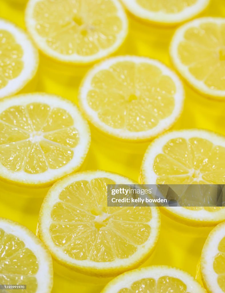 Yellow lemon slices healthy diet detox background