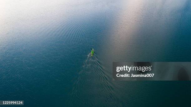 a drone shooting a kayak floating in lake - simple living stock pictures, royalty-free photos & images