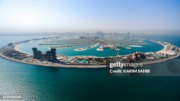 This picture taken on July 8, 2020 shows an aerial view of the Atlantis The Palm luxury hotel resort and the under-construction Royal Atlantis Resort...