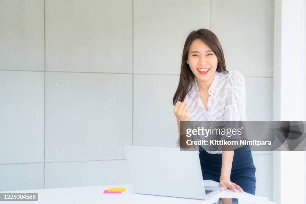 businesswoman showing hand rise in office;success concept. - effortless experience stock pictures, royalty-free photos & images