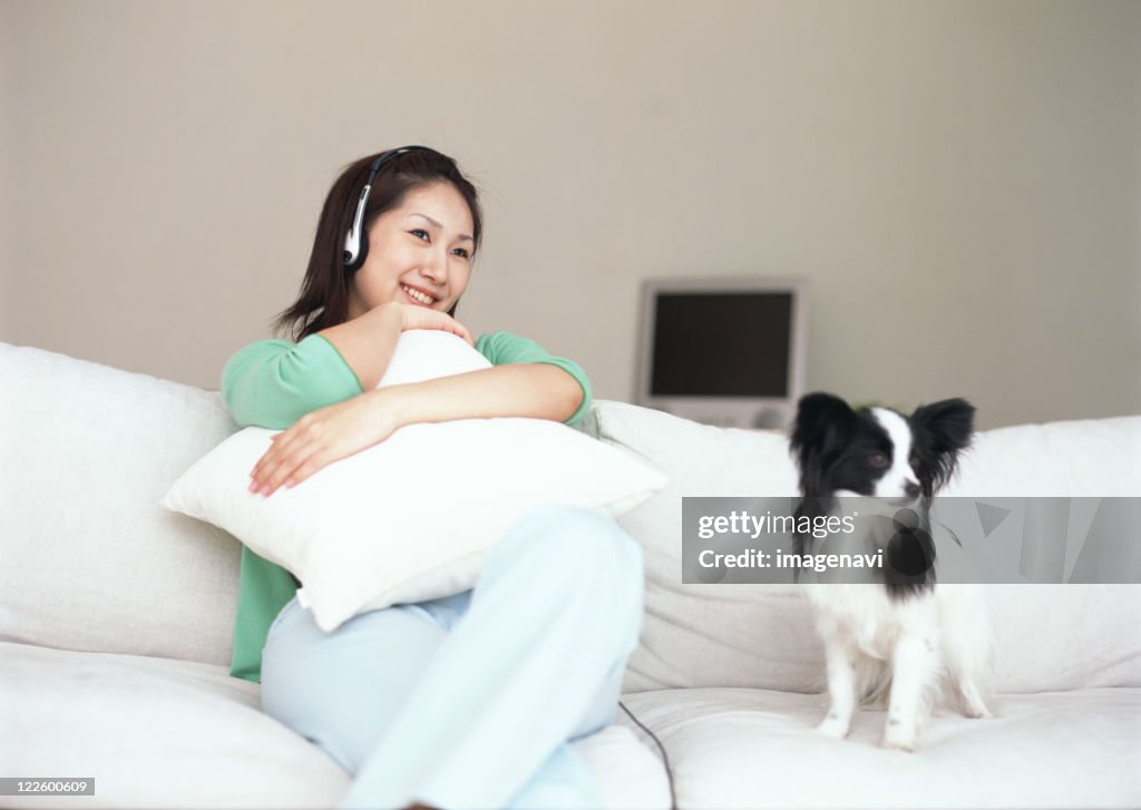 Woman relaxed with dog on sofa
