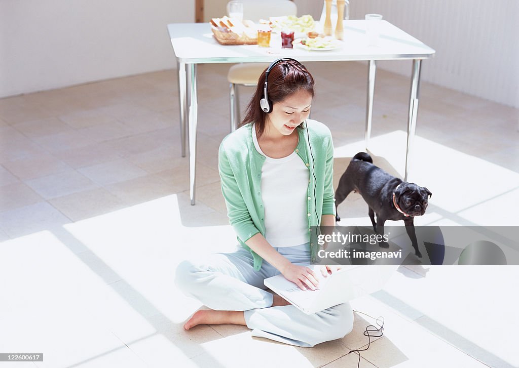 Woman using laptop on floor