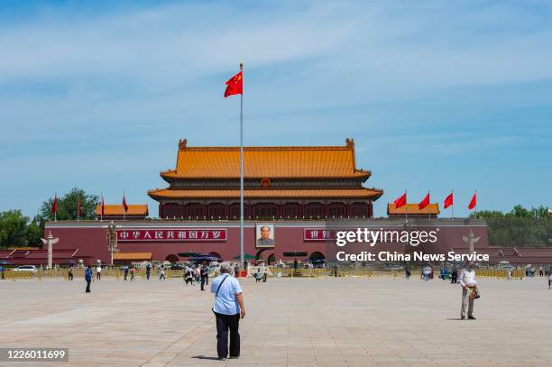 People stand in front of Tiananmen Gate on May 20, 2020 in Beijing, China.