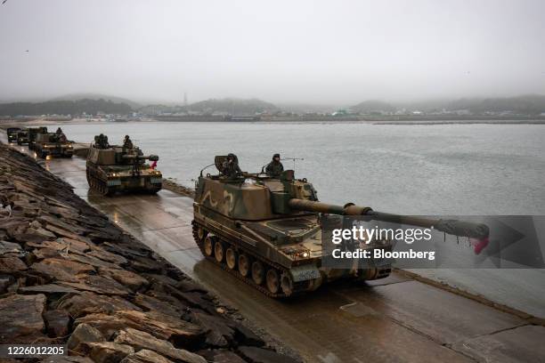 South Korean Marine Corps soldiers ride in K-9 tanks during a military exercise on Yeonpyeong Island, South Korea, on Thursday, June 25, 2020. On the...