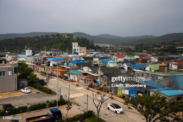 Houses and buildings stand in a village on Yeonpyeong Island, South Korea, on Friday, June 26, 2020. On the sleepy island of Yeonpyeong, the threat...