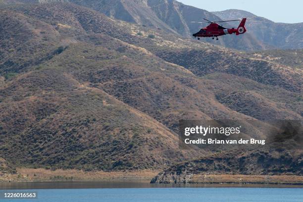 Coast Guard helicopter crew searchers the shoreline at Lake Piru for missing actress Naya Rivera on Thursday, July 9, 2020 in Lake Piru, CA.