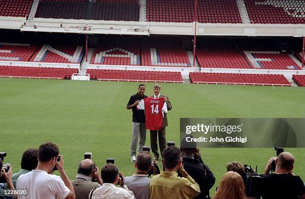 Thierry Henry signs for Arsenal Football Club and is presented to the media by his new manager Arsene Wenger during a photo-call held at Highbury in...