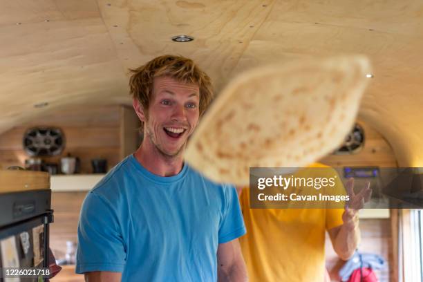 two people making funny face while flipping crepes inside school bus - throwing food stock pictures, royalty-free photos & images