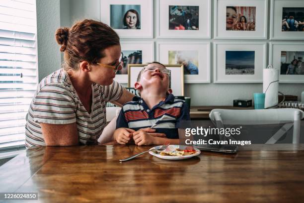 mom holding boy while he is crying - tantrum stock pictures, royalty-free photos & images