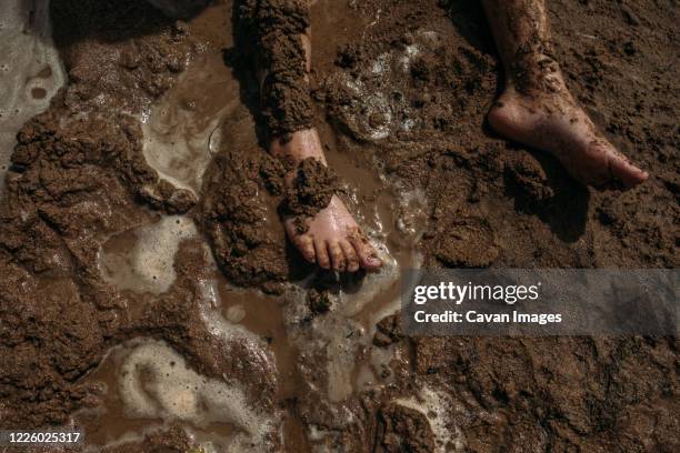 young child's legs covered in mud - people covered in mud stock pictures, royalty-free photos & images