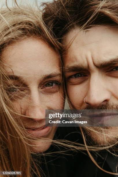 up close of man and woman with eyes next to each other and windy hair - look alike imagens e fotografias de stock