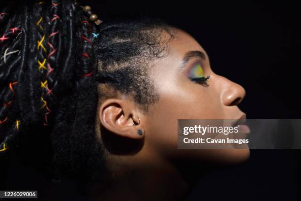 interior chiaroscuro portrait of young black woman - dark skin tone stock pictures, royalty-free photos & images