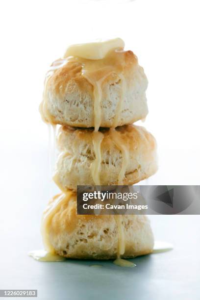 stack of buttermilk biscuits with butter dripping - buttermilchkeks stock-fotos und bilder