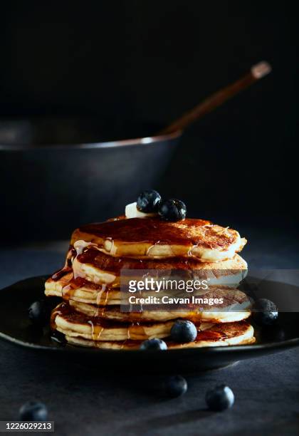 stack of blueberry pancakes with syrup - american pancakes stock pictures, royalty-free photos & images