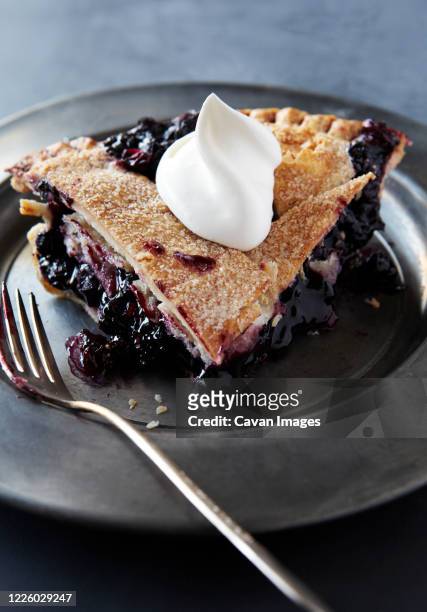 slice of blueberry pie with whip cream - blueberry pie stock pictures, royalty-free photos & images