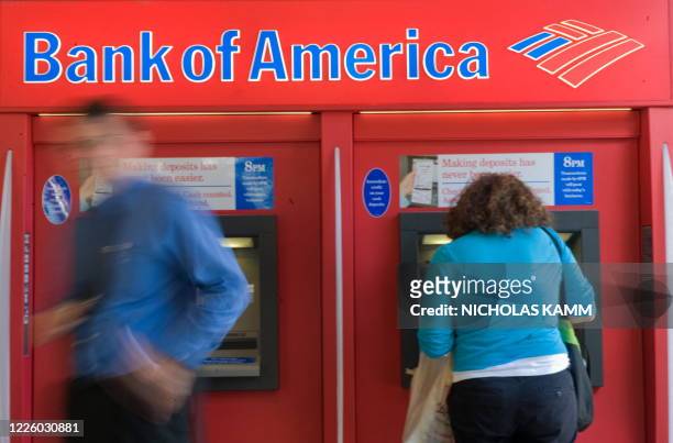 People use a Bank of America automatic teller machine in Washington on September 15, 2008. Bank of America announced earlier in the day it was buying...