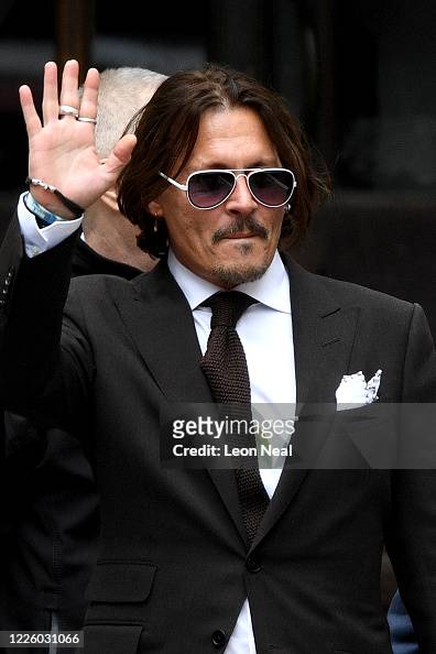 Johnny Depp waves as he leaves the Royal Courts of Justice, Strand on ...