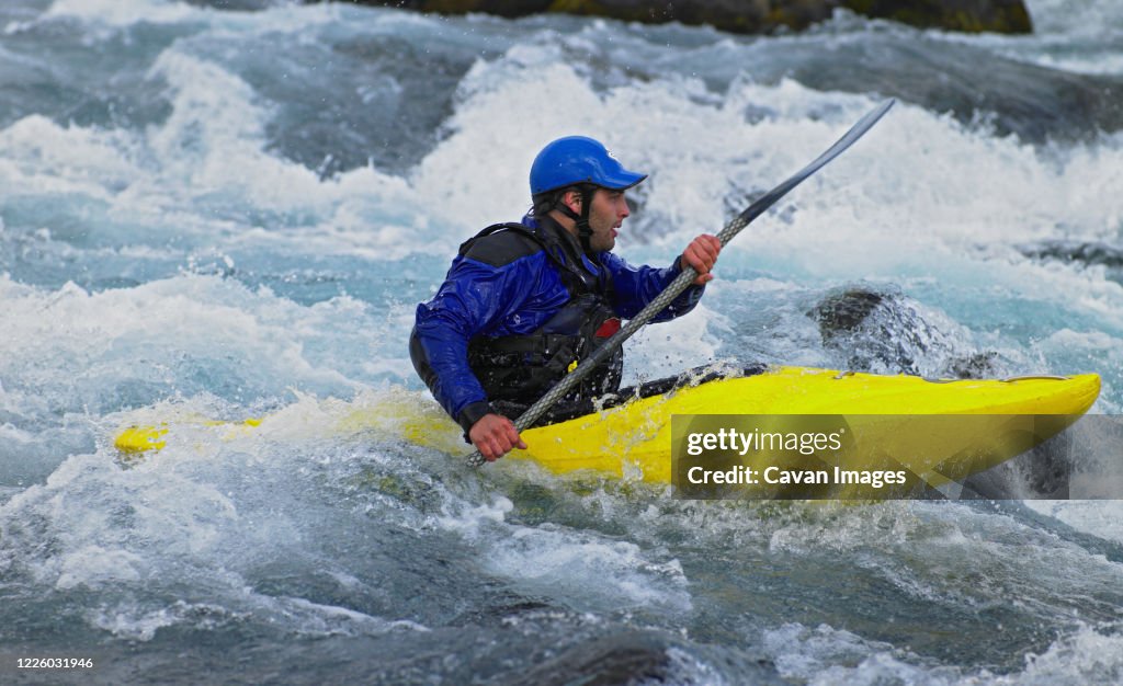 Man going on his white water kayak rapids in an Icelandic river