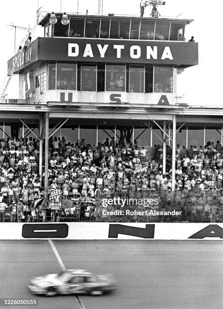 Driver Morgan Shepherd crosses the finish line in second place at the 1983 Firecracker 400 stock car race at Daytona International Speedway in...