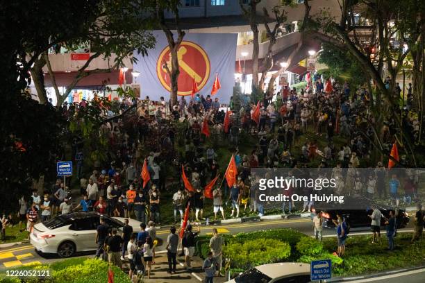 Supporters of opposition Workers Party gather and celebrate as results of sample counts are being announced during the counting of votes of the...