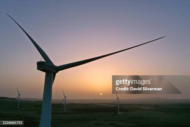 Sunrise aerial view of new wind turbines constructed between vineyards and fruit orchards as part of the Valley of Tears wind turbines farm project...