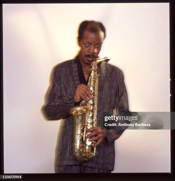 Portrait of American Jazz musician and composer Ornette Coleman as he poses with a saxophone, New York, 1977.