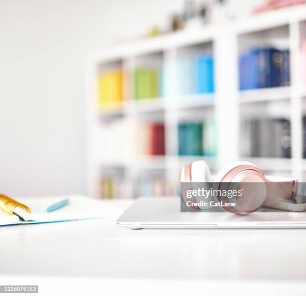 modern home office with white desk, laptop and headphones - school system stock pictures, royalty-free photos & images