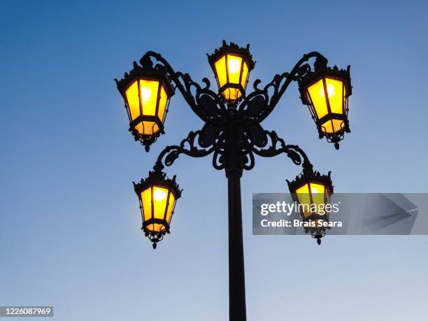 streetlights against blue sky. - street light post stock pictures, royalty-free photos & images