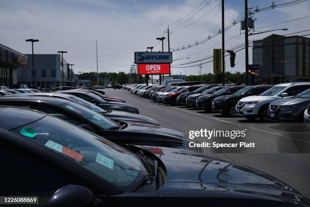 Cars sit in a dealership lot on the first day that dealerships are allowed to open to the public on May 20, 2020 in Linden, New Jersey. Despite the...