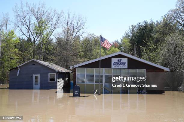 Main street is flooded after water from the Tittabawassee River breached a nearby dam on May 20, 2020 in Sanford, Michigan. Thousands of residents...