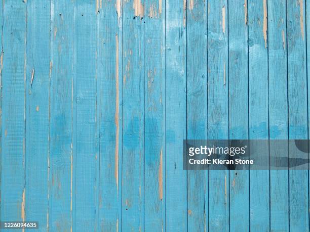 peeling blue paint on weathered boards - blue wooden table stock-fotos und bilder