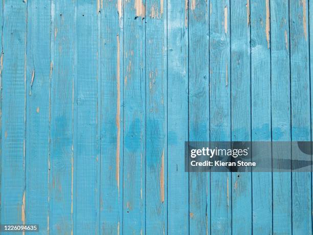 peeling blue paint on weathered boards - damaged fence stock pictures, royalty-free photos & images