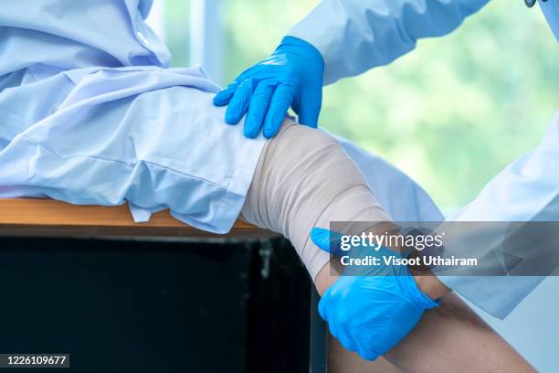 doctor examines the patient's knee. - knee surgery stock-fotos und bilder