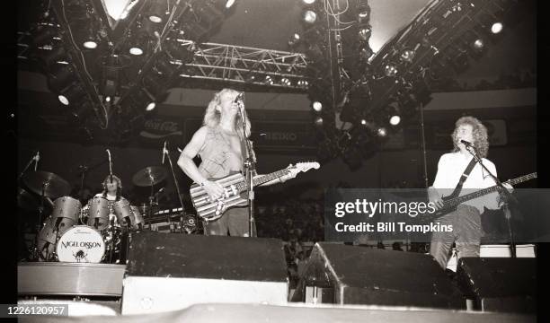 Bill Tompkins/Getty Images Davey Johnstone, Nigel Olsson andNeil Murray perform at Madison Square Garden 1983 in New York City.