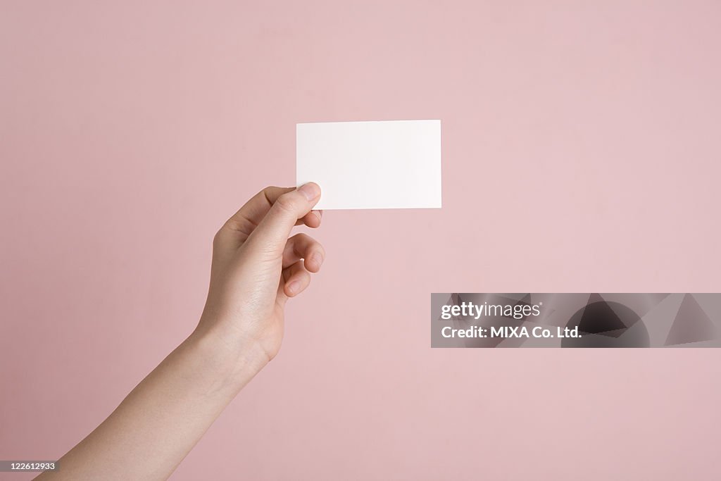 Woman's hand holding card