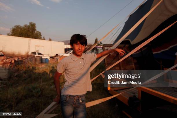 Boy watches as circus performers train amidst coronavirus on May 20, 2020 in Queretaro, Mexico. As nonessential activities are not permitted during...