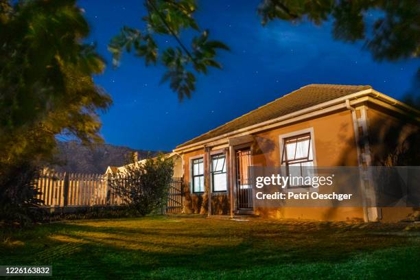 nighttime image of a middle-class home in south africa. - south suburban recreation center stock pictures, royalty-free photos & images