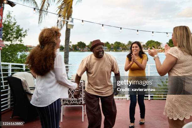 african-american senior man dancing with hispanic friends - applauding balcony stock pictures, royalty-free photos & images