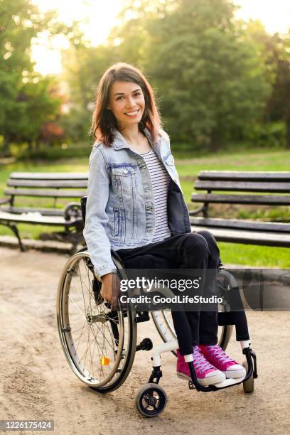 woman in a wheelchair - paralysis stock pictures, royalty-free photos & images