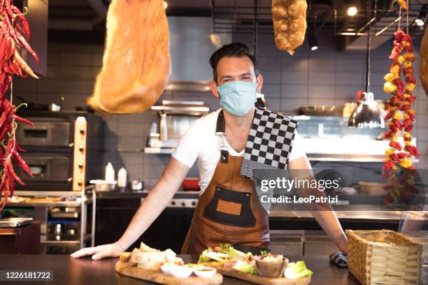 barista posing for a portrait wearing protective mask - reopening ceremony stock pictures, royalty-free photos & images