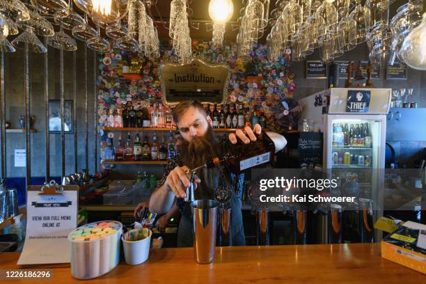 Bar manager Oscar of The Institution mixes a cocktail on May 21, 2020 in Christchurch, New Zealand. Bars are able to reopen across New Zealand today...