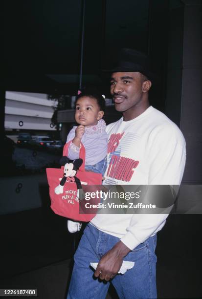 American heavyweight boxer Evander Holyfield, carrying his daughter, attends 10th Annual American Cinema Awards, held at the Beverly Hilton Hotel in...