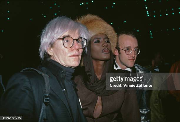 American artist Andy Warhol , Jamaican model and singer Grace Jones, and American artist Keith Haring attend an American Foundation for AIDS Research...