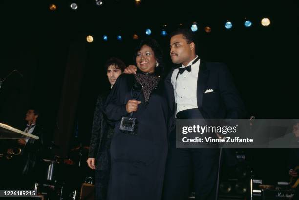 American singer and musician Peter Wolf with American model Harlean Harris , widow of American soul singer Jackie Wilson, and the Wilson's son, John...