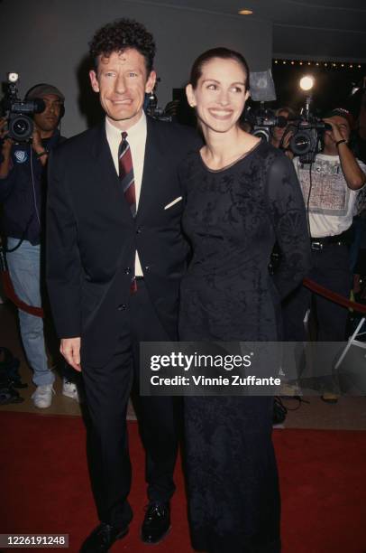 American singer-songwriter Lyle Lovett and his wife, American actress Julia Roberts attend the premiere of 'The Pelican Brief', held at the Mann...